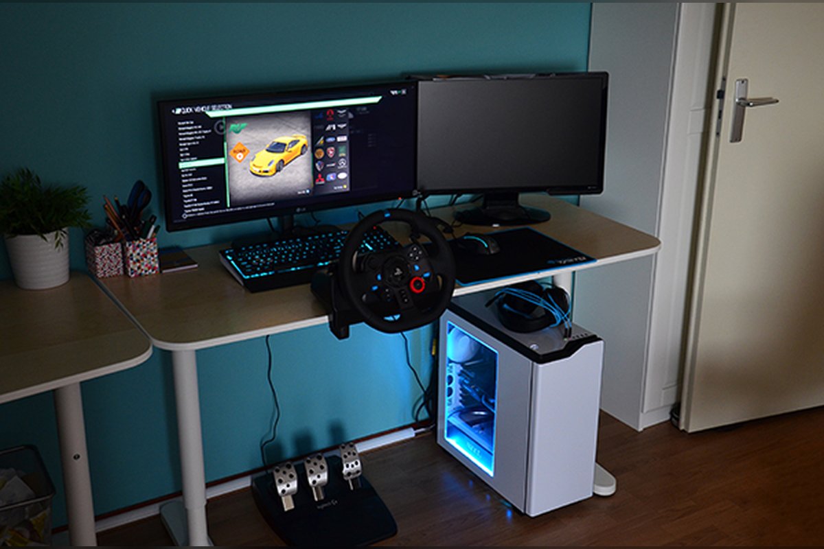 Example: Logitech G29 wheel clamped to a desk with monitors and PC